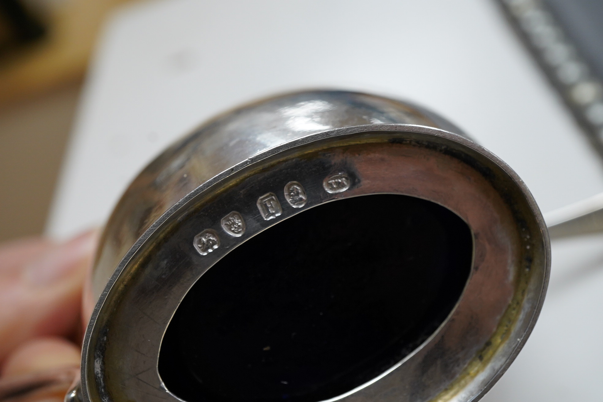 A George III engraved oval silver mustard pot, by James Mince, London, 1805, height 69mm, together with an associated silver mustard ladle, Thomas Dicks, London, 1808.